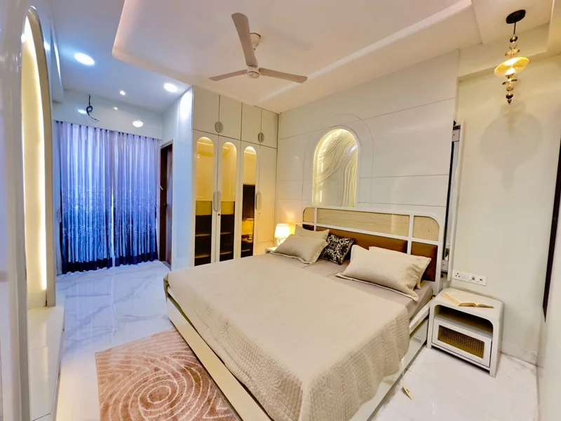 Kalyan EVA actual flat: bedroom with warm lighting